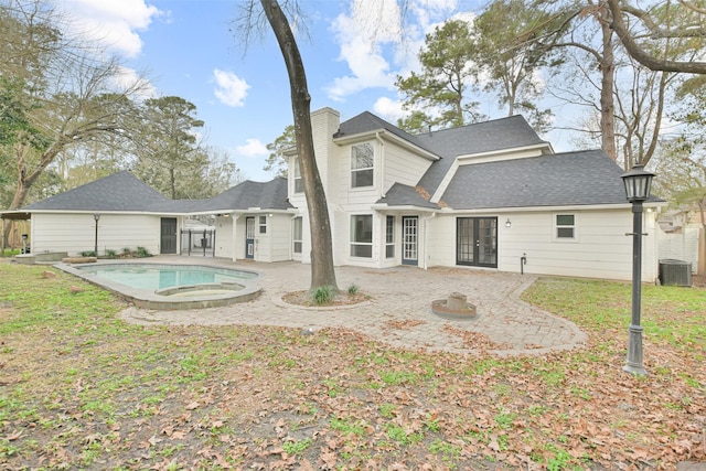 rear view of property with a patio and central AC