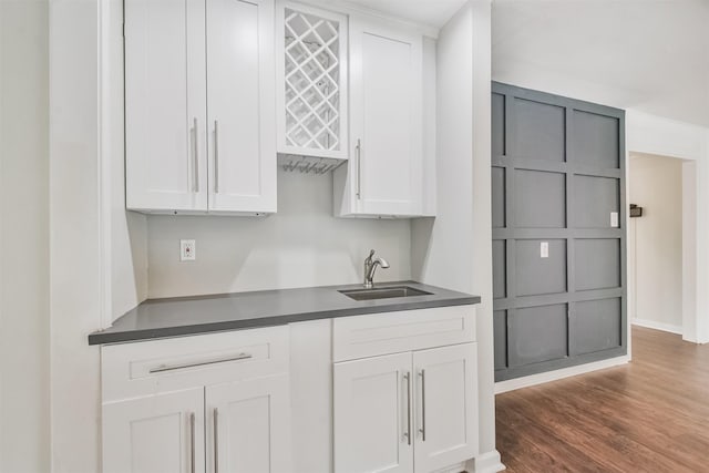 kitchen featuring white cabinetry, sink, and dark hardwood / wood-style flooring