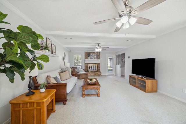 carpeted living area with baseboards, a fireplace, ornamental molding, and ceiling fan