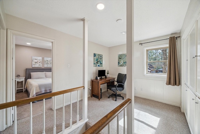 home office with light carpet and baseboards