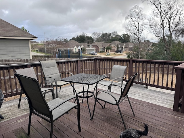 wooden deck featuring a trampoline