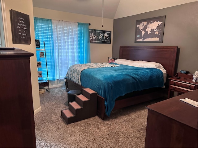 carpeted bedroom with lofted ceiling