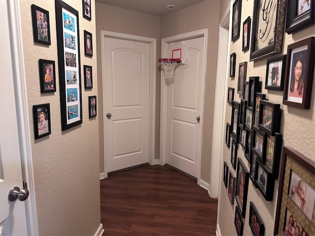 corridor with dark hardwood / wood-style flooring