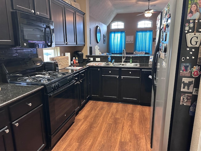 kitchen with hardwood / wood-style floors, black appliances, sink, ceiling fan, and kitchen peninsula