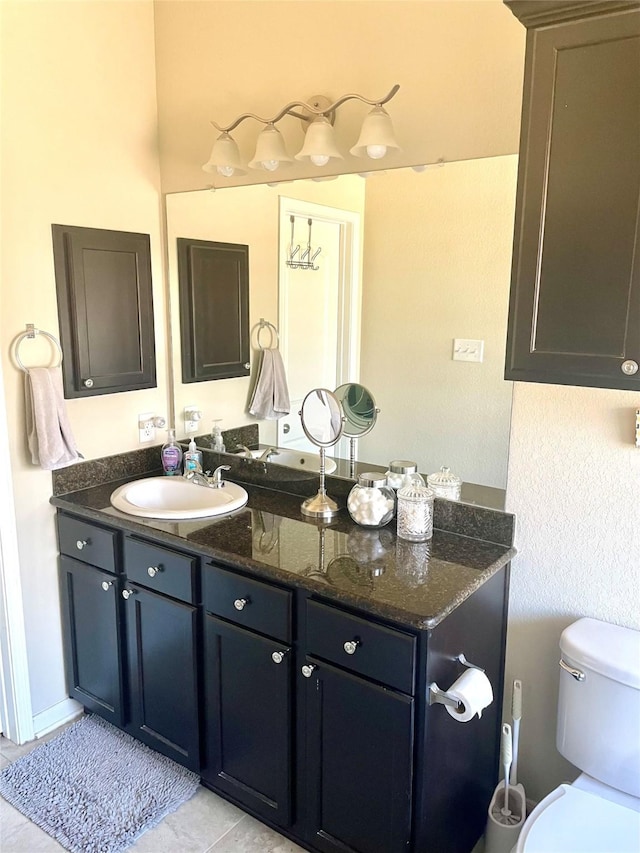 bathroom with vanity, tile patterned flooring, and toilet