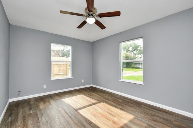 empty room featuring dark wood-type flooring and ceiling fan