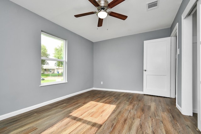 unfurnished bedroom with dark wood-type flooring and ceiling fan