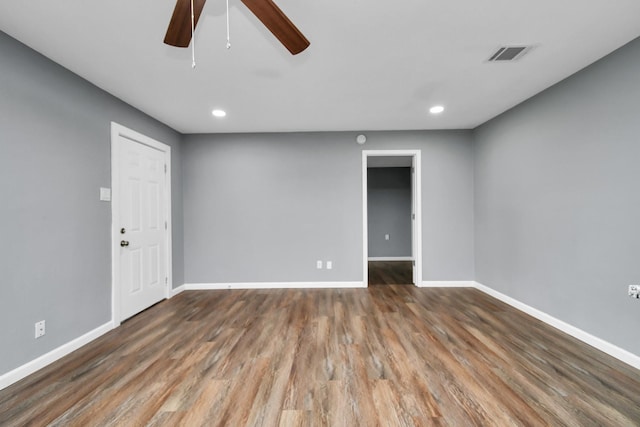 unfurnished room with ceiling fan and dark hardwood / wood-style flooring