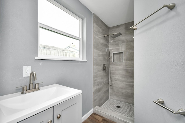 bathroom featuring vanity and tiled shower