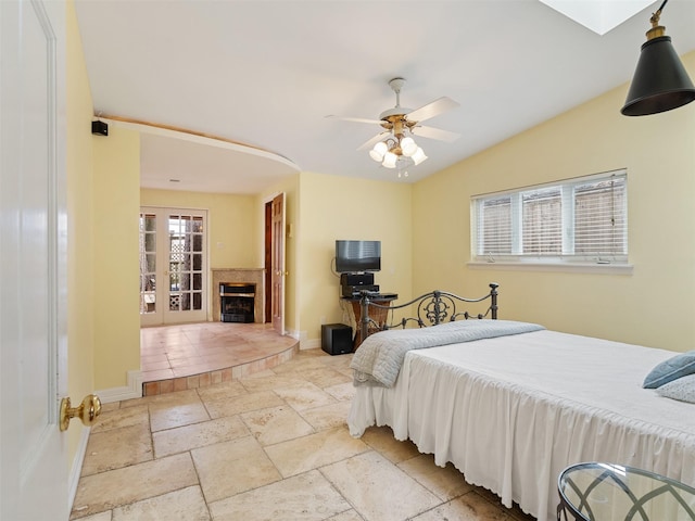 bedroom featuring ceiling fan and vaulted ceiling with skylight