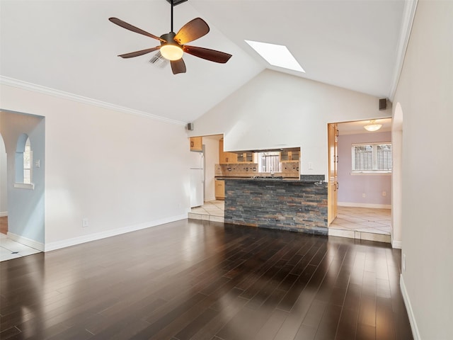 living room featuring a skylight, ornamental molding, ceiling fan, and light wood-type flooring