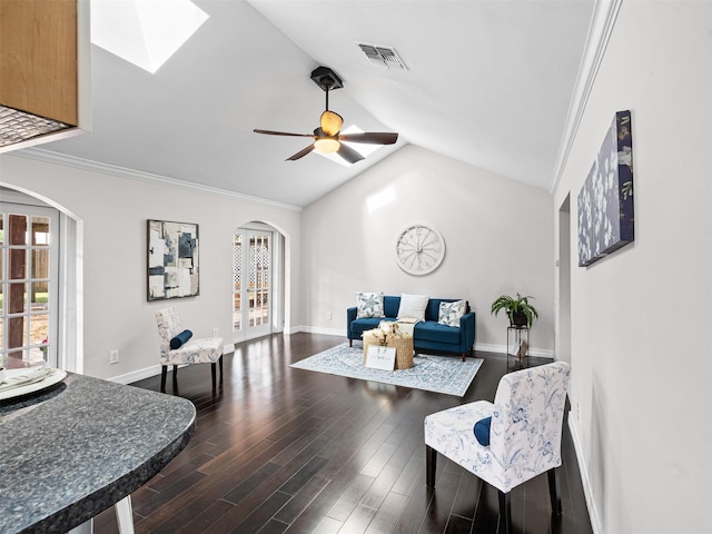 living room featuring arched walkways, visible vents, vaulted ceiling with skylight, and dark wood-style flooring