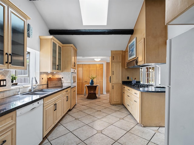 kitchen featuring a sink, glass insert cabinets, light tile patterned floors, backsplash, and white appliances