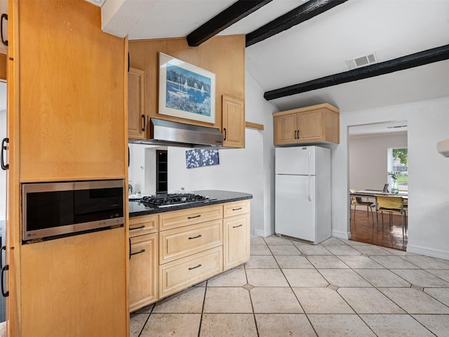 kitchen with visible vents, lofted ceiling with beams, freestanding refrigerator, exhaust hood, and gas stovetop