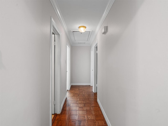 corridor with attic access, crown molding, and baseboards