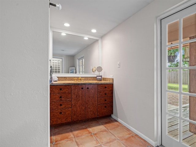 bathroom featuring tile patterned floors, vanity, recessed lighting, and baseboards