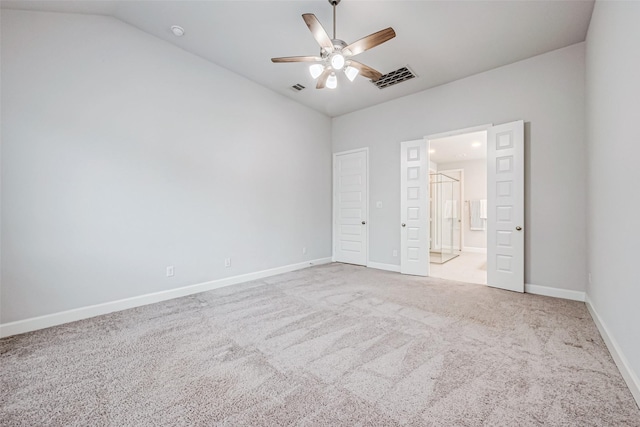 unfurnished bedroom featuring carpet floors, baseboards, visible vents, and vaulted ceiling