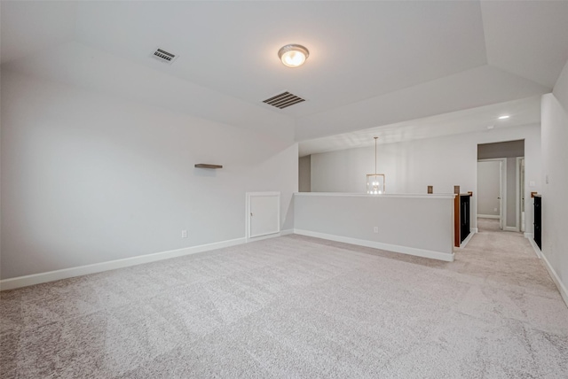 unfurnished room with light carpet, visible vents, and baseboards