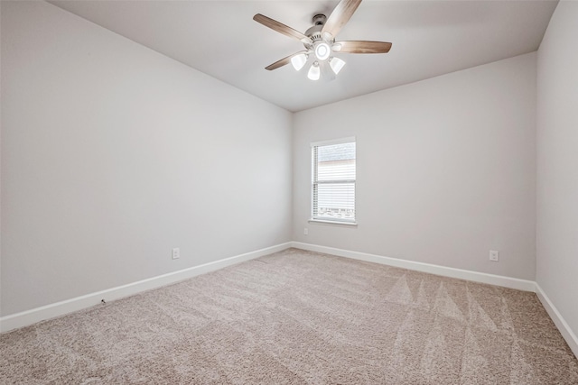 unfurnished room with carpet, a ceiling fan, and baseboards