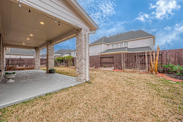 view of yard with a patio area and a fenced backyard