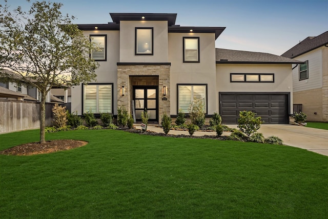 view of front of house with a yard and a garage