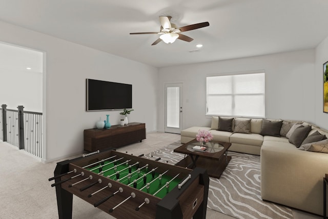 carpeted living room with ceiling fan