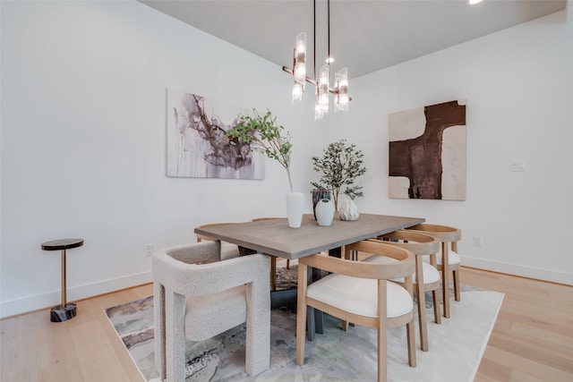 310 E 27th St, Houston, TX 77008 - dining area featuring baseboards, wood finished floors, and an inviting chandelier
