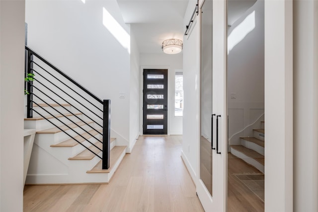 310 E 27th St, Houston, TX 77008 - entryway featuring light wood-style floors, stairway, and a barn door