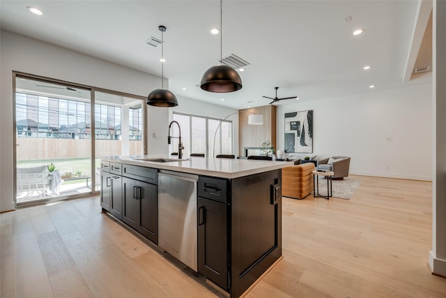 310 E 27th St, Houston, TX 77008 - kitchen with a sink, light wood-style floors, dishwasher, light countertops, and visible vents