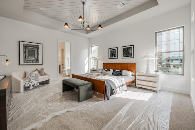 310 E 27th St, Houston, TX 77008 - bedroom with a raised ceiling, visible vents, carpet floors, ensuite bath, and baseboards