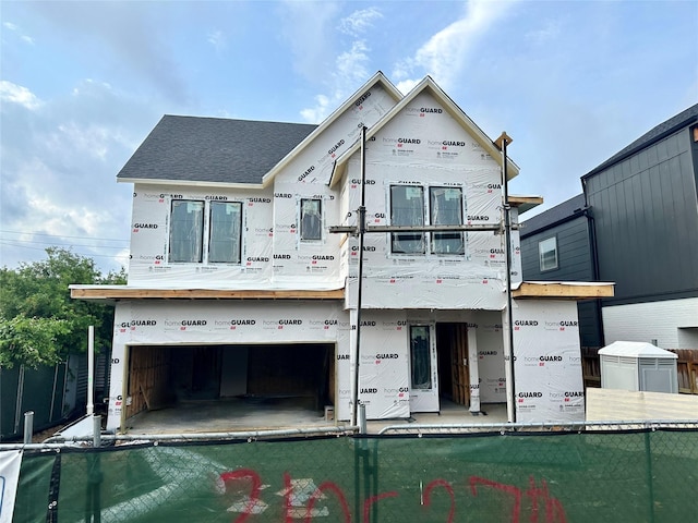310 E 27th St, Houston, TX 77008 - exterior space featuring fence, a shingled roof, and a garage
