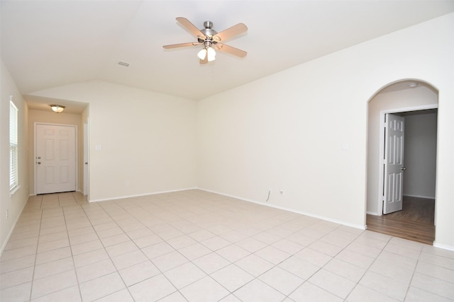 unfurnished room featuring light tile patterned flooring, ceiling fan, and lofted ceiling