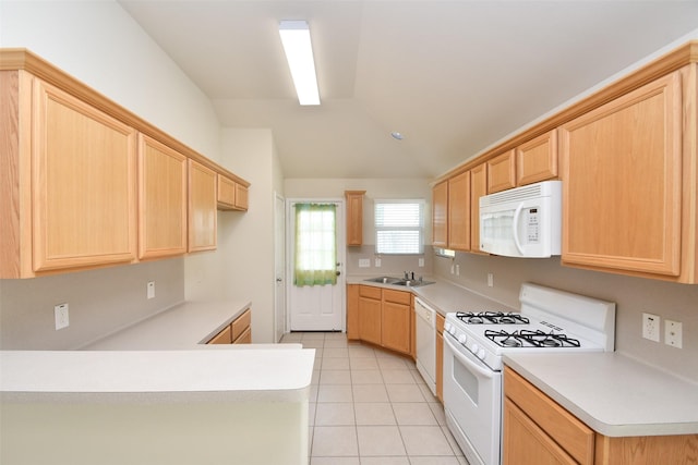 kitchen with sink, light tile patterned floors, light brown cabinetry, and white appliances