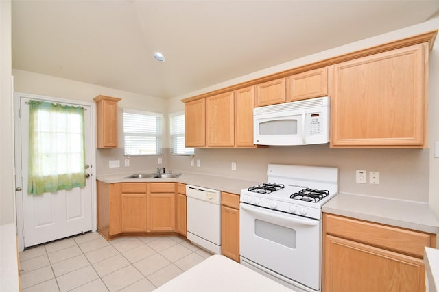 kitchen with white appliances, sink, light brown cabinets, and light tile patterned floors