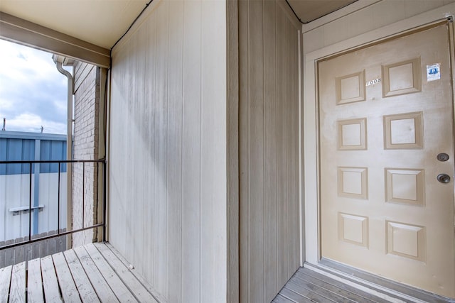 view of exterior entry featuring a balcony