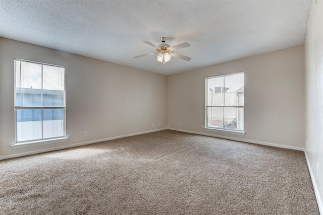 empty room featuring carpet flooring, a textured ceiling, and ceiling fan