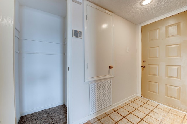 entryway featuring a textured ceiling