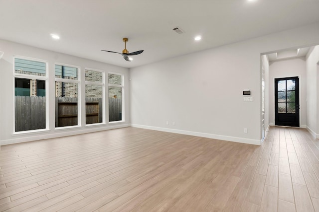 unfurnished living room with ceiling fan and light wood-type flooring