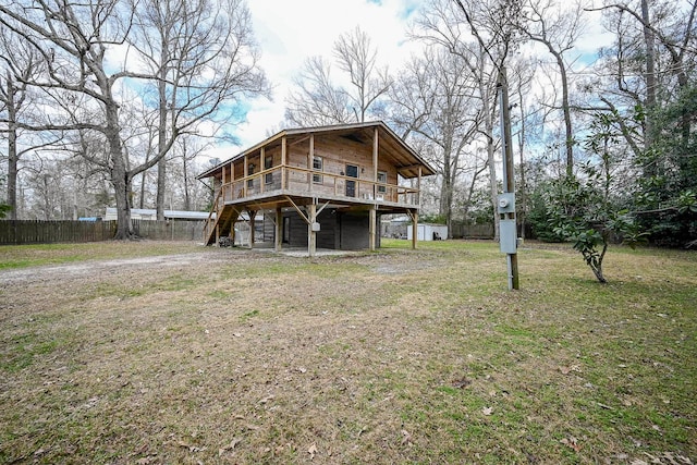 back of property featuring a yard and a deck