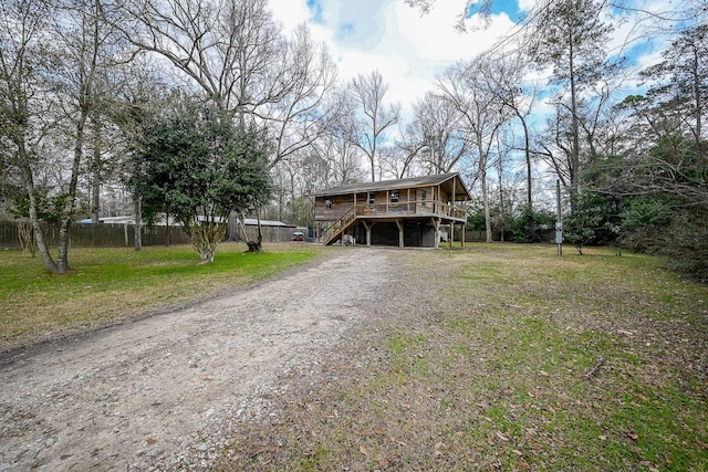 view of front facade with a front lawn and a deck