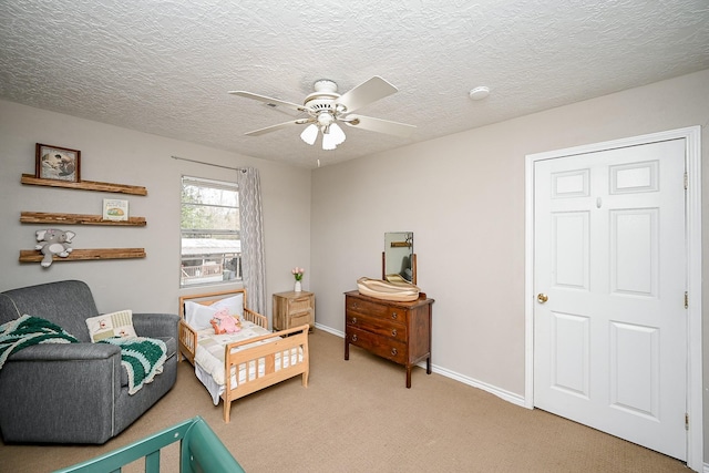 bedroom featuring ceiling fan, carpet flooring, and a textured ceiling