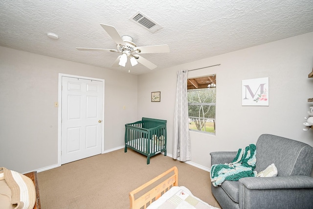 living area with carpet flooring, a textured ceiling, and ceiling fan