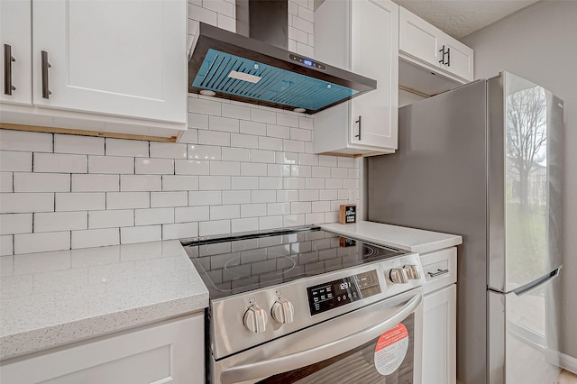 kitchen with white cabinetry, tasteful backsplash, light stone countertops, stainless steel range with electric cooktop, and wall chimney exhaust hood