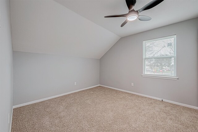 bonus room with vaulted ceiling, carpet, and ceiling fan