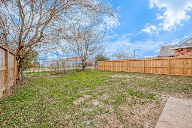 view of yard with a fenced backyard