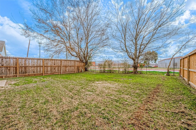 view of yard with a fenced backyard