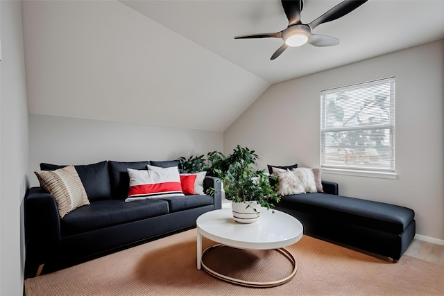 living room featuring baseboards, lofted ceiling, and ceiling fan