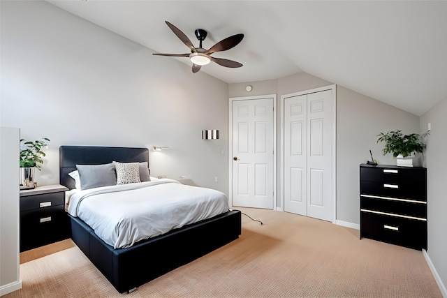 bedroom with light colored carpet, baseboards, lofted ceiling, and a ceiling fan