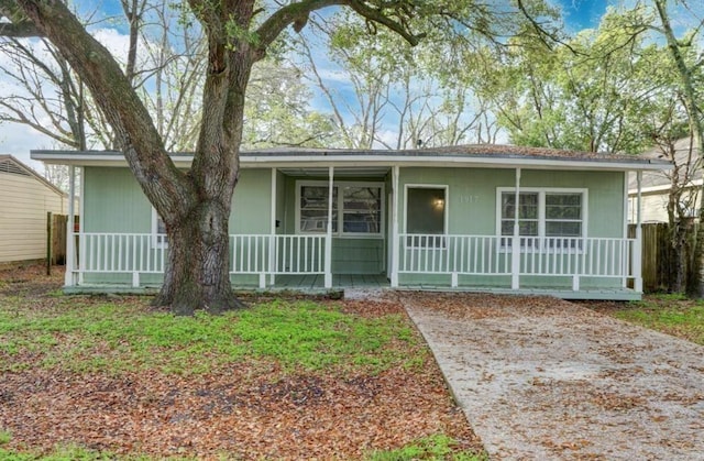 single story home featuring covered porch