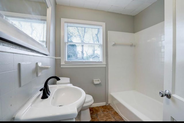 bathroom featuring tile walls, sink, tile patterned flooring, and toilet